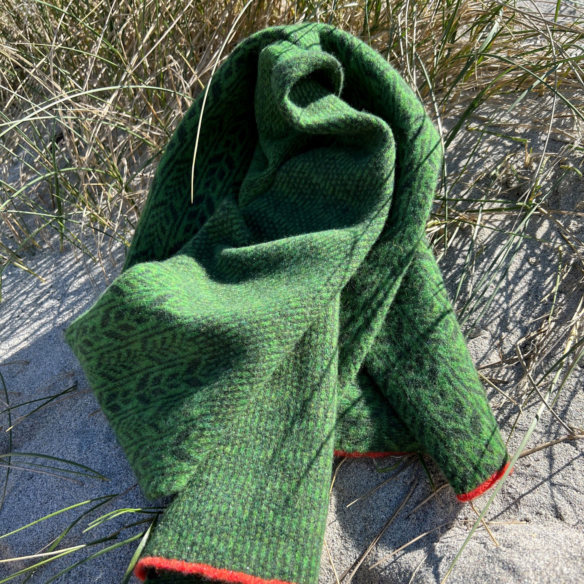 All our scarves are knitted using a punch-card system on a manual vintage knitting machine and are 100% Merino lamb's wool.  Dry clean or wash by hand. Seen here in Juniper green.