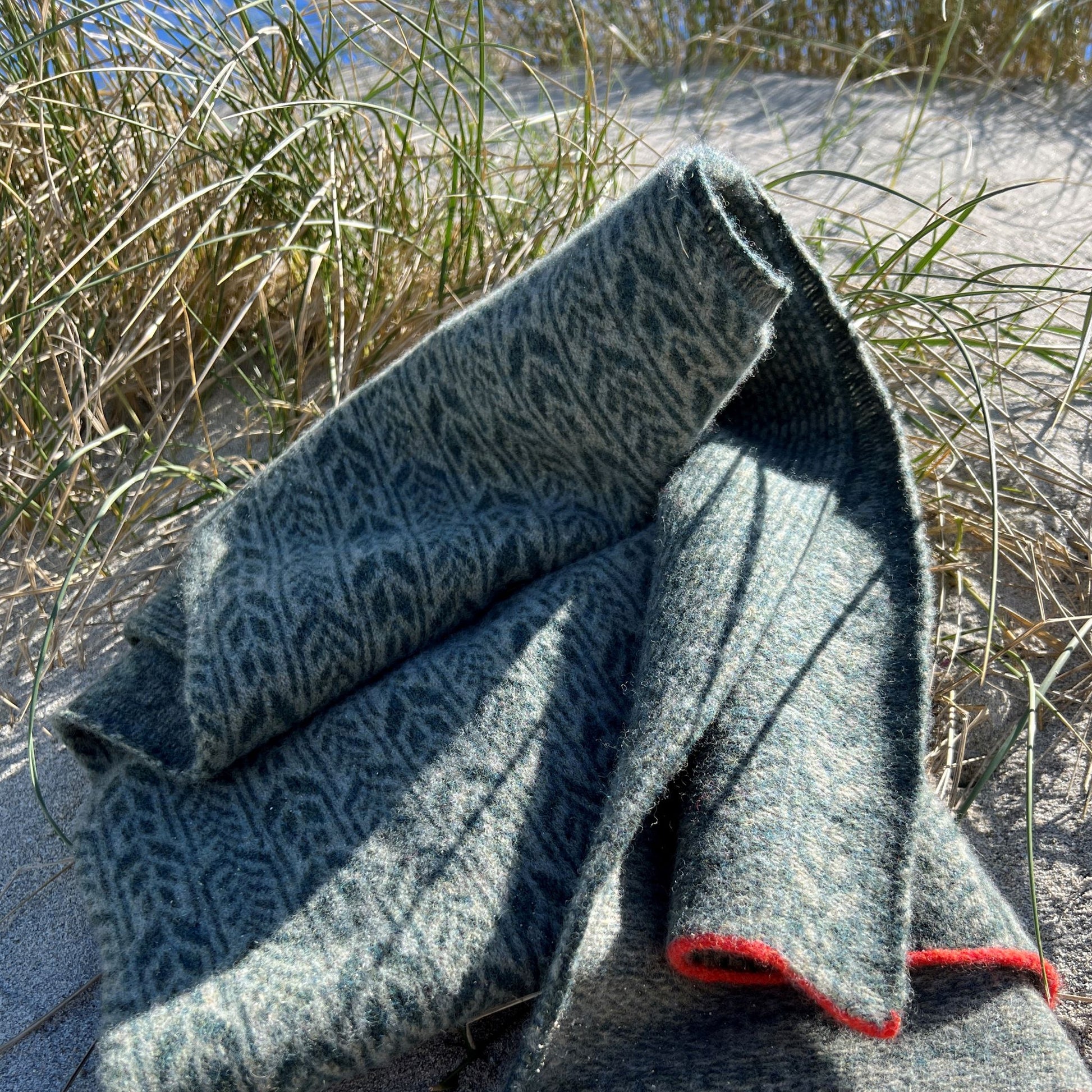 All our scarves are knitted using a punch-card system on a manual vintage knitting machine and are 100% Merino lamb's wool.  Dry clean or wash by hand. Seen here in Moss.