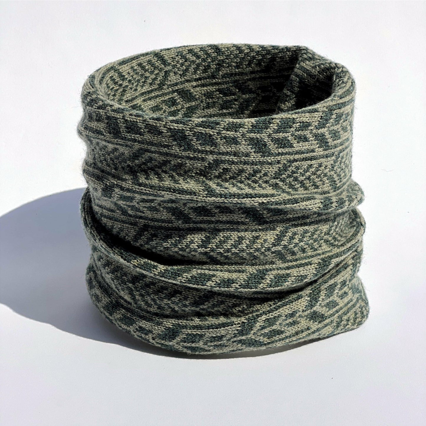 Our scarves and neck warmers are all knitted using a punch-card system on a manual vintage knitting machine and made from pure Merino lamb's wool, with bespoke two-colour fair isle patterns unique to Hebridean Journey. This colour is Moss.