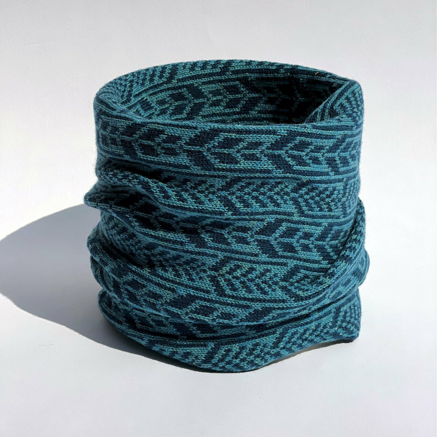 Our scarves and neck warmers are all knitted using a punch-card system on a manual vintage knitting machine and made from pure Merino lamb's wool, with bespoke two-colour fair isle patterns unique to Hebridean Journey. This colour is Ocean.